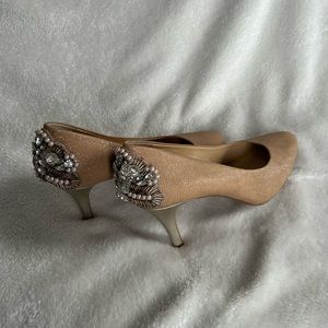 Beautiful Carmel colored shoes with embellishments on the back heel.